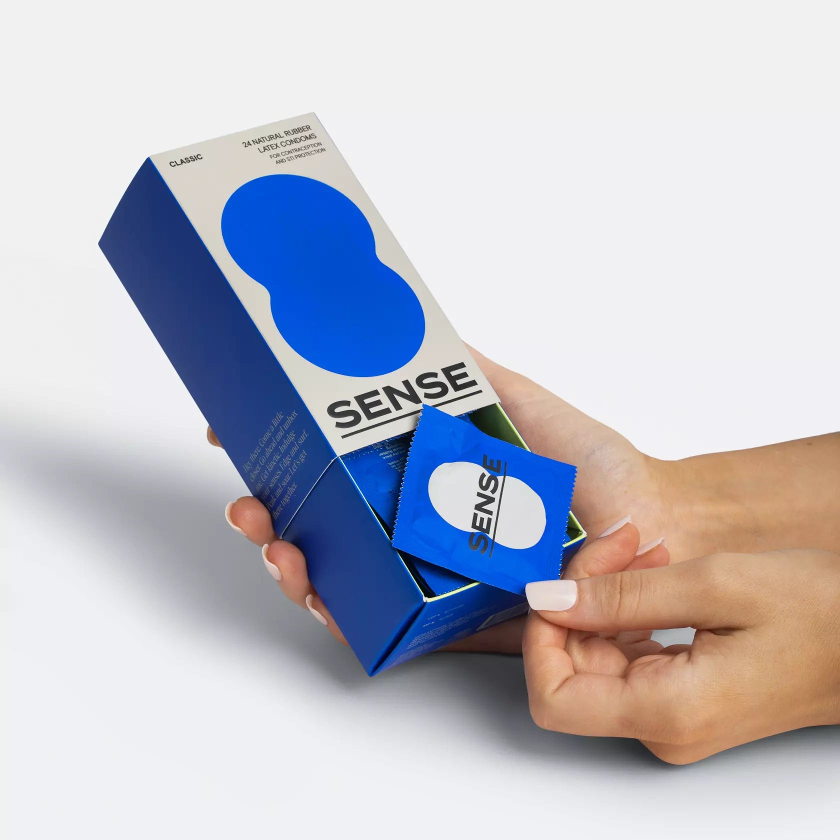 Woman hands opening a 24 pack of Sense premium natural rubber latex condoms